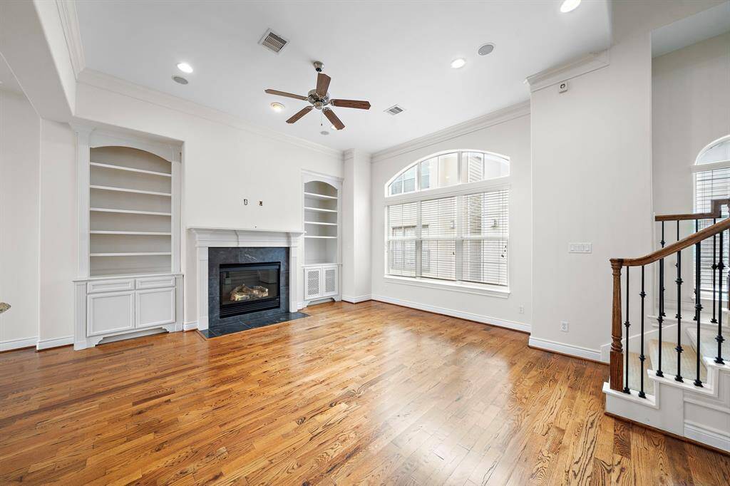 living room with built-in cabinets andfireplace