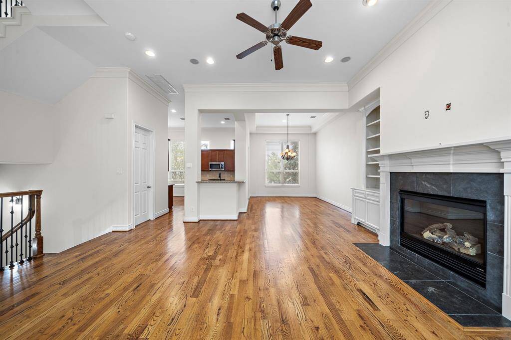 This stunning living room features built-in cabinets for stylish storage and a beautiful fireplace for the perfect warm ambiance.