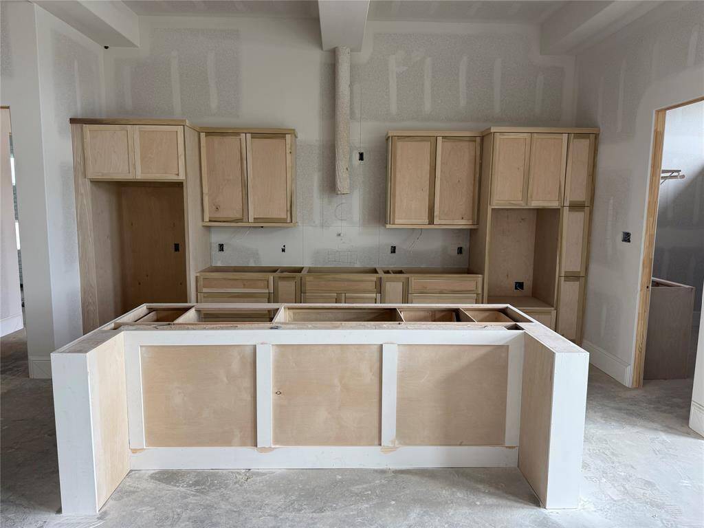 Island with sink soon to be covered with quartz countertops!