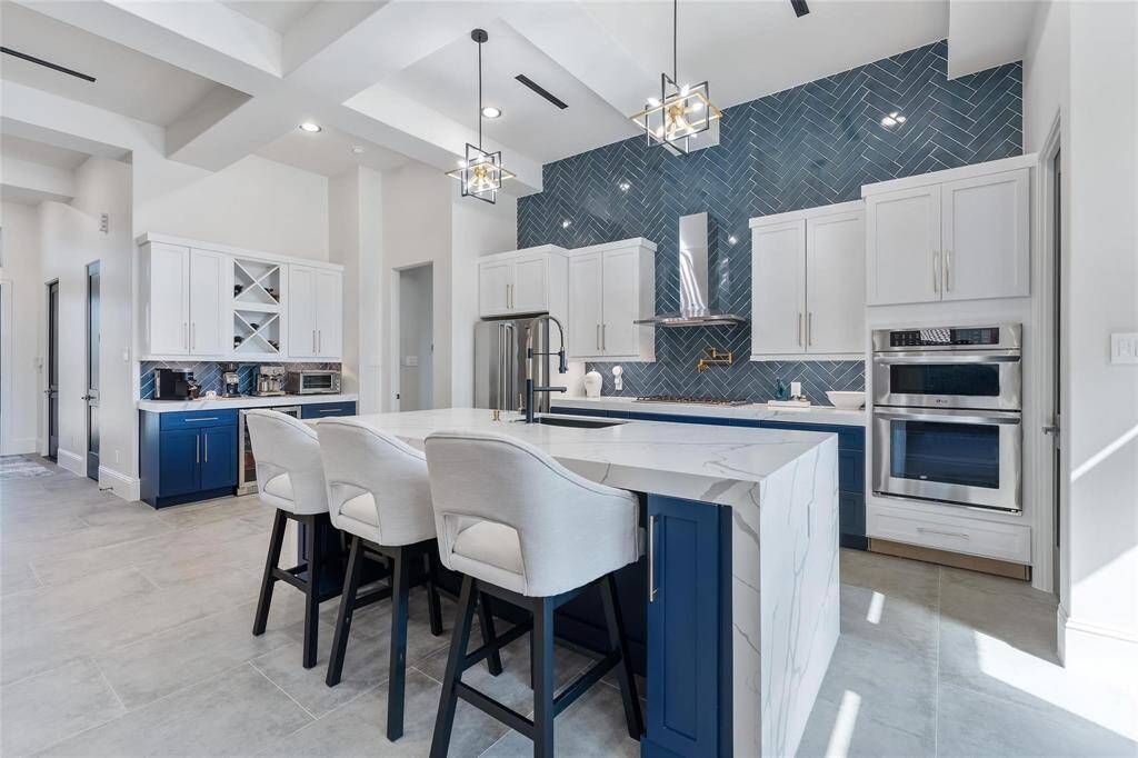 Model home view of kitchen with quartz countertop.