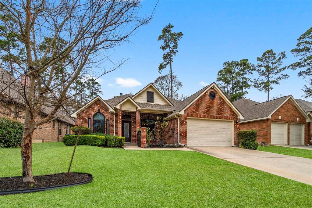 Charming brick home with a two-car garage, nestled in a well-maintained neighborhood. Features a tidy front lawn, manicured shrubs, and mature trees, offering great curb appeal.