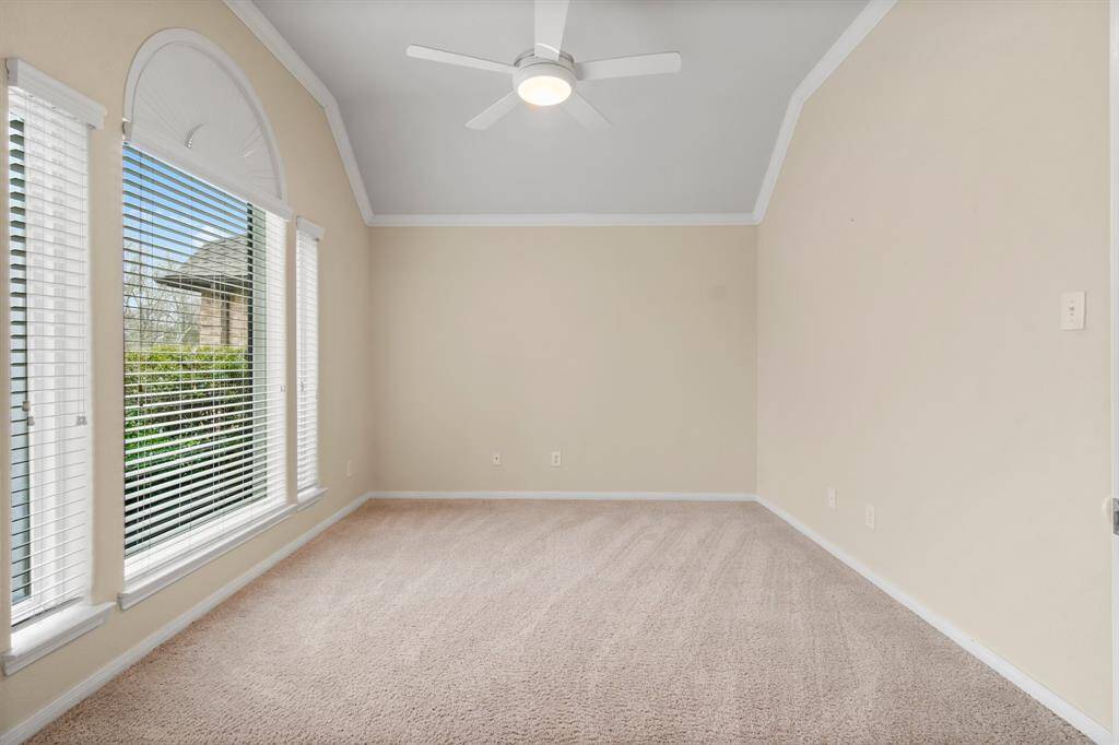This inviting entryway leads to a spacious open floor plan featuring tiled and carpeted areas, high ceilings, and elegant archways. The room is well-lit with natural light, and includes a cozy fireplace, perfect for family living and entertaining.