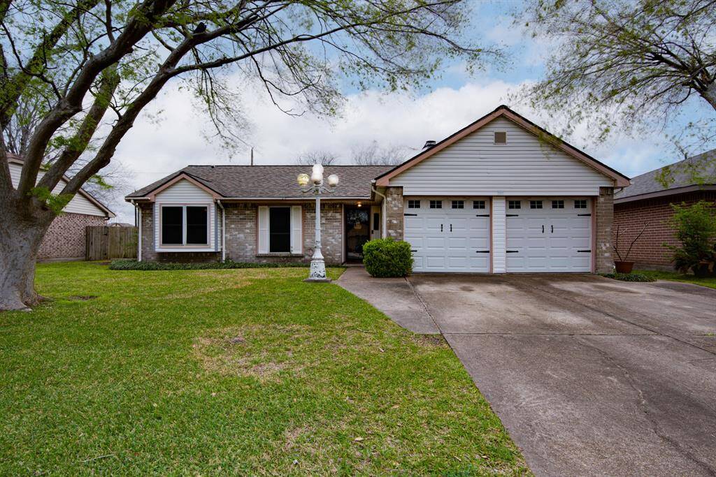 Charming single-story home with a brick facade and two-car garage.