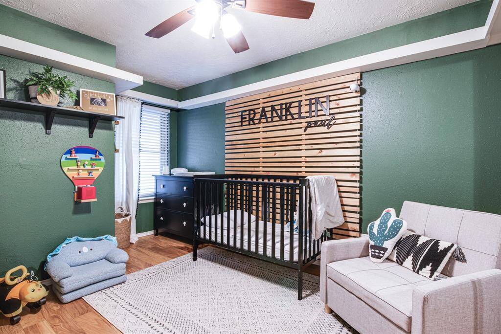 The room is well-lit with a ceiling fan and natural light from a window. Ideal for a child's room!