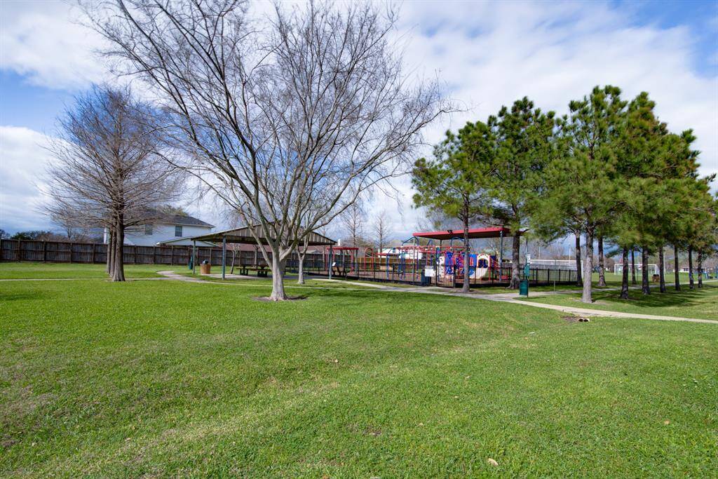 Community park with a playground, and a covered picnic area, offering a great outdoor space for families.