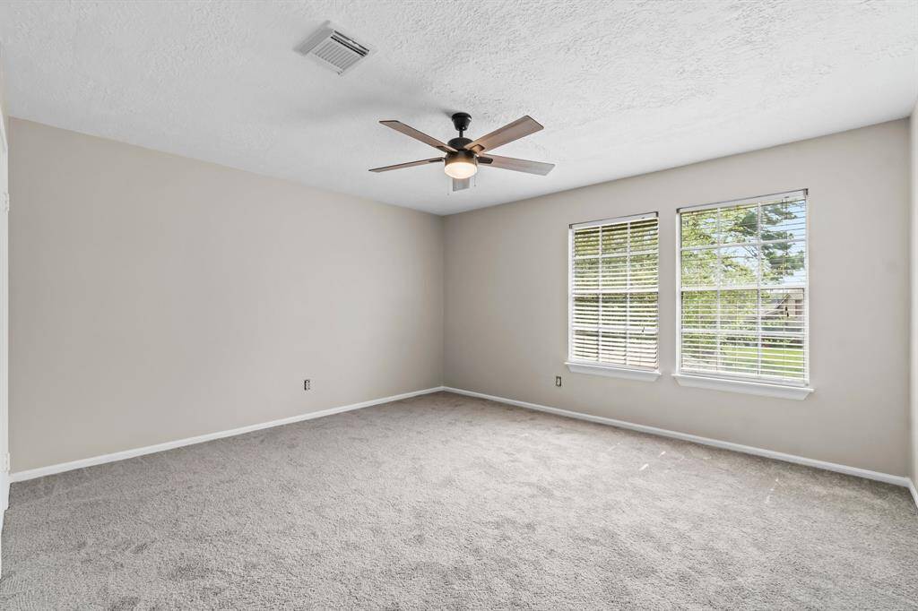 Spacious secondary bedroom with new carpet and paint.