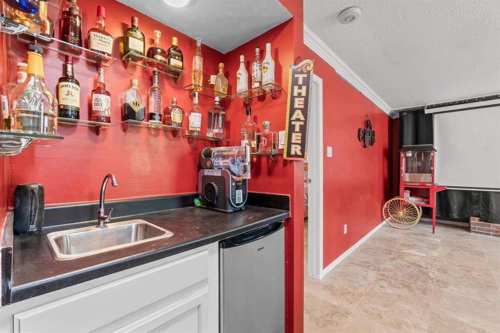 Wet bar located downstairs with sink + mini fridge.