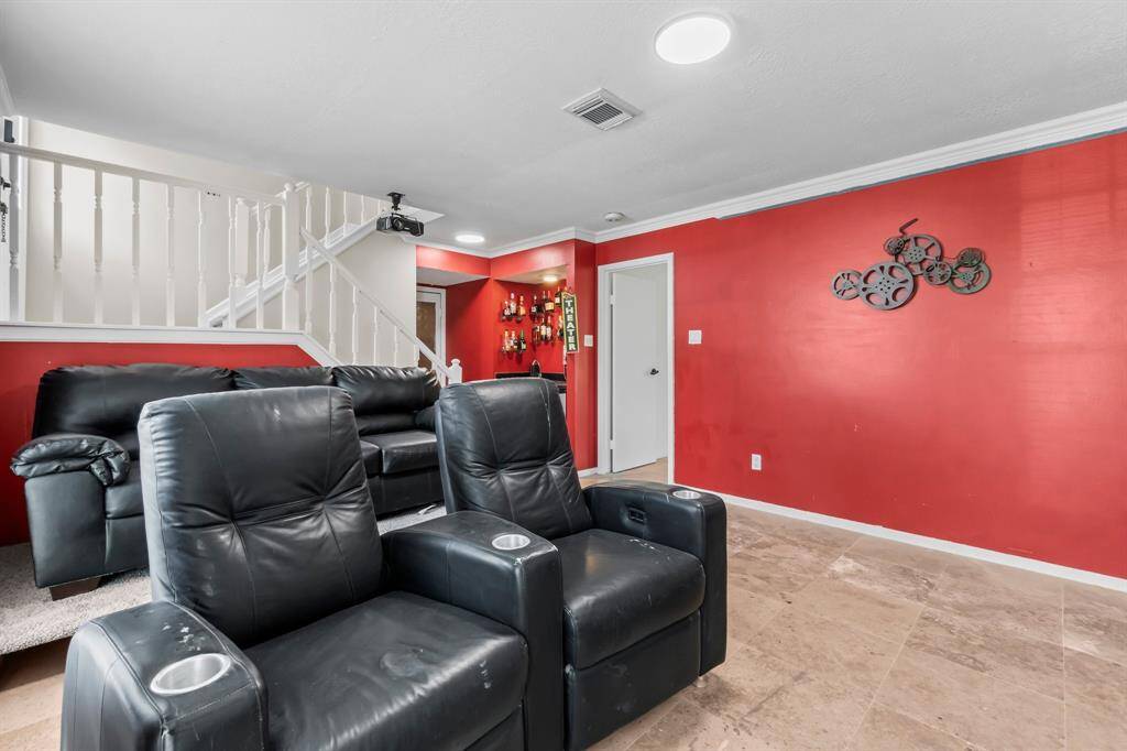 This space is used as a theatre room but can be transformed into whatever fits your needs. Unseen is a half bath downstairs underneath the staircase.