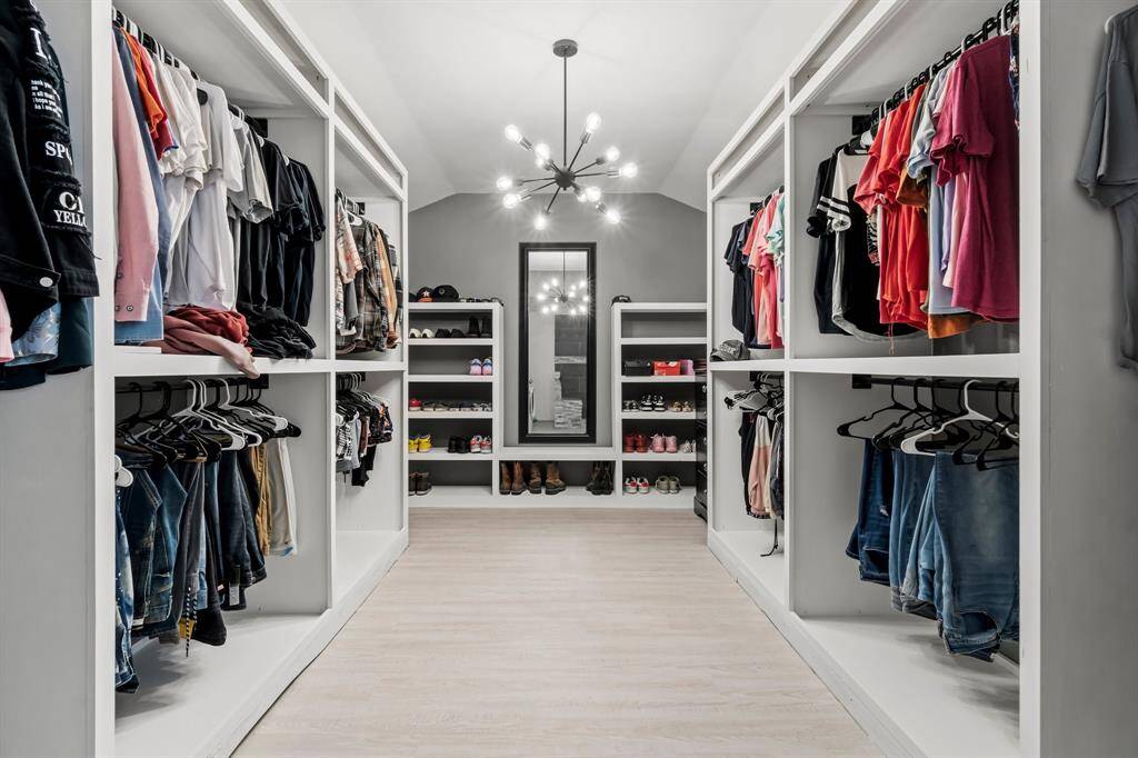 HUGE walk in and reimagined closet with built ins and luxury lighting.