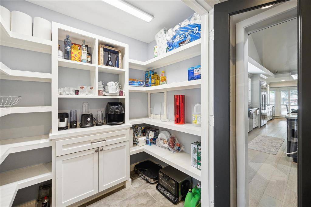 Now THIS is a Pantry. Behind glass paned doors is this thoughtfully designed Pantry ample enough to store your Cosco purchases, the specialty appliances you never use, in addition to food and water.
