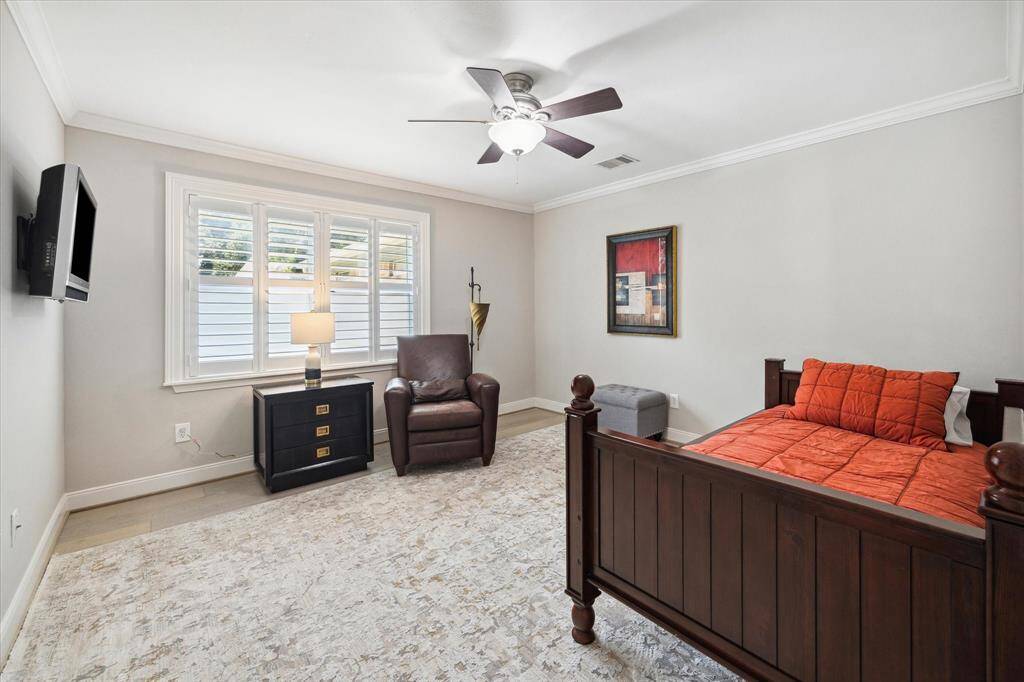 The secondary Bedrooms are nicely sized and feature hardwood floors, crown mouldings and plantation shutters.