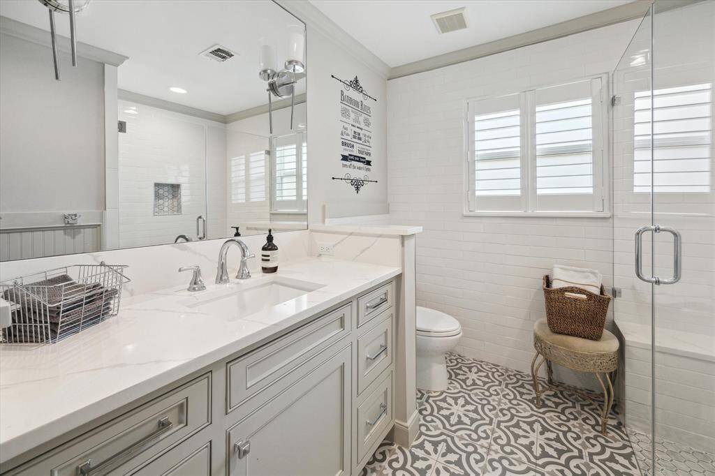 The secondary Bedrooms share this updated Bath featuring custom vanity and a stall shower.