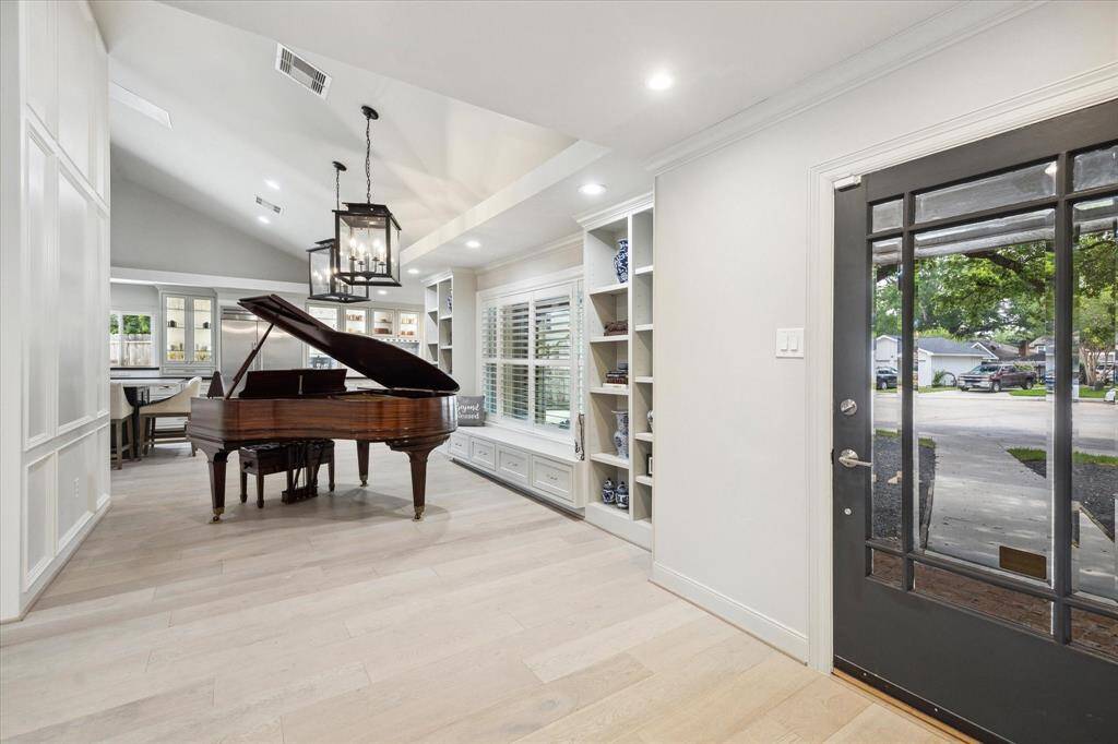 The Front Room features dual built in bookshelves with a window seat, with additional storage beneath, in between.