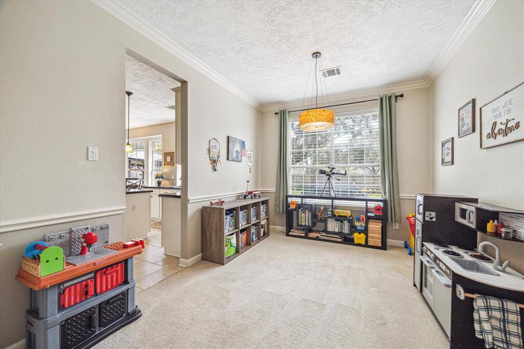 Located just off the kitchen, the formal dining room is currently utilized as a game room.