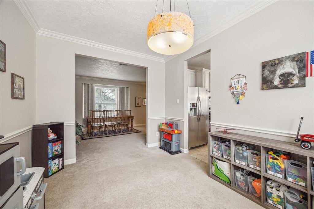The formal dining room is currently being utilized as a game room.