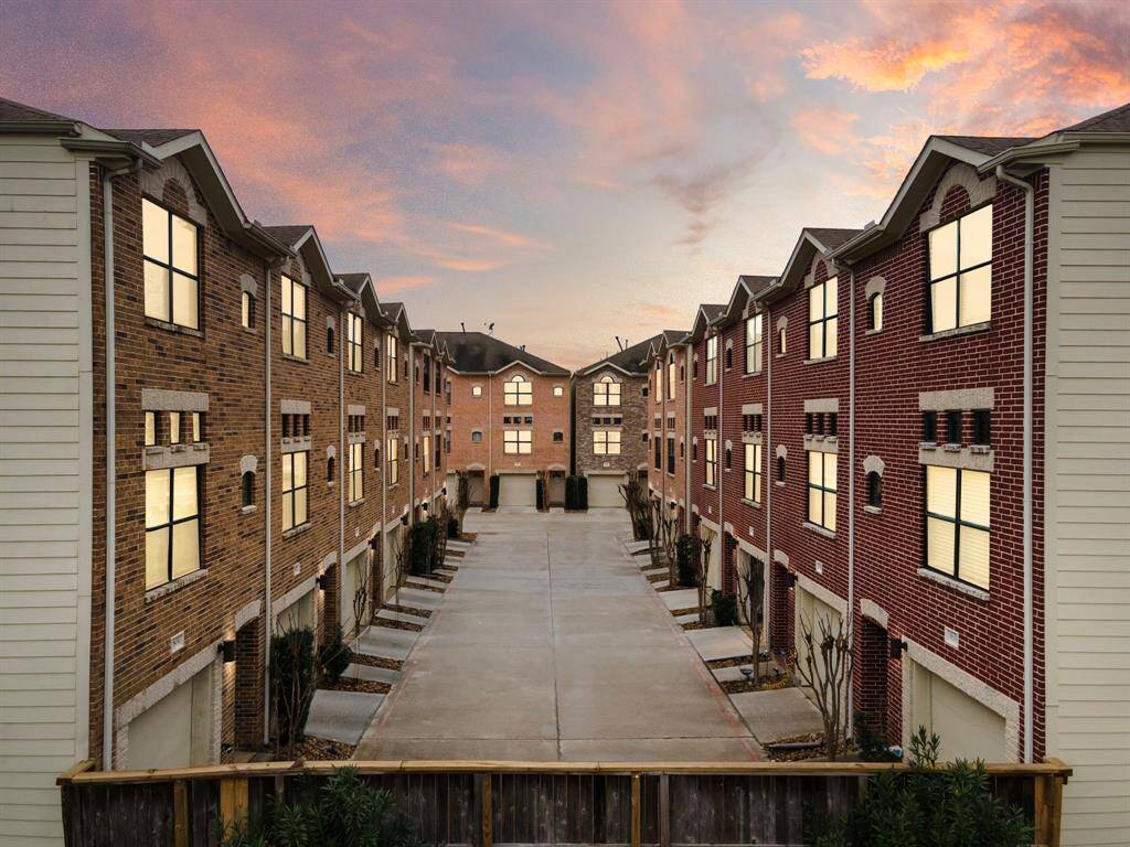 Located in a private, gated community, this townhome features a brick exterior with secure entry access. Individual garages provide security and extra storage within this low-maintenance, lock-and-leave property.