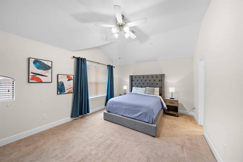 Carpeted floors provide a warm and inviting atmosphere in this bedroom. This room features a window and closet, offering both light and storage space.