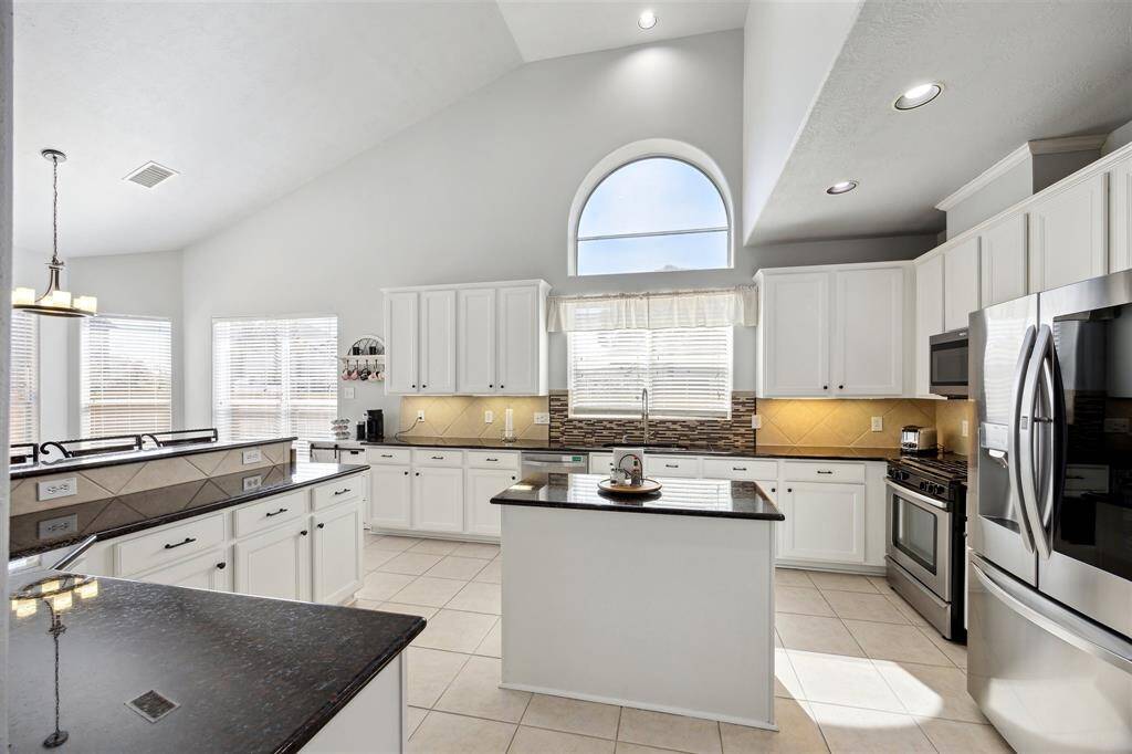 And another view of the kitchen.  So much counterspace!  Undermount lighting, recessed lighting, tile flooring and lots of windows!