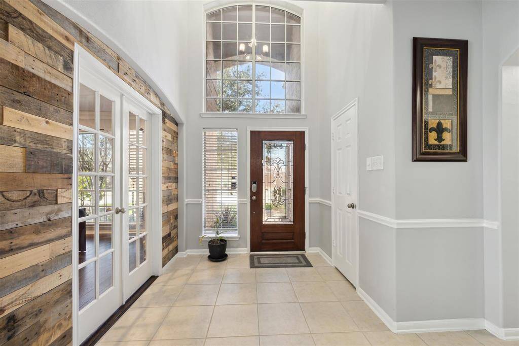 Wow! The is the entry way with soaring ceiling and lots of light coming in through the windows and beveled glass door. The French Door on the left lead into the study/office. And the door on the right is the coat closet. No carpet on the first floor (except in the primary bedroom closets).