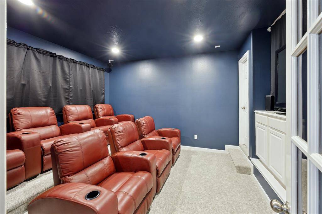 And the home theater!  This was painted a darker color recently, and black out curtains were hung.  The door on the left leads to a long closet behind.   What a great room to watch sports and movies!