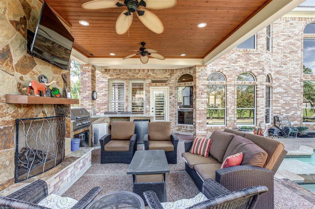 Relaxation is key to this backyard paradise where you can swim or keep tabs on your favorite teams all the while enjoying grilling at the summer kitchen.