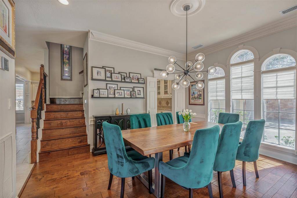 Gorgeous wood flooring continues up the staircase and just beyond the dining room you can see a glimpse of the butler's pantry for entertaining and serving at special times.