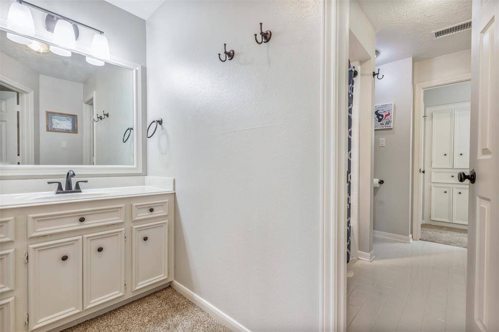 Jack and Jill type shared shower/bath areas with each bedroom having their own vanity in the bathroom. Notice the cabinets for linen and storage, too!