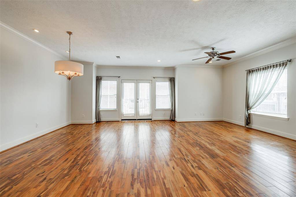 Plenty of natural light in this space. Dining area to the right has custom chandelier.