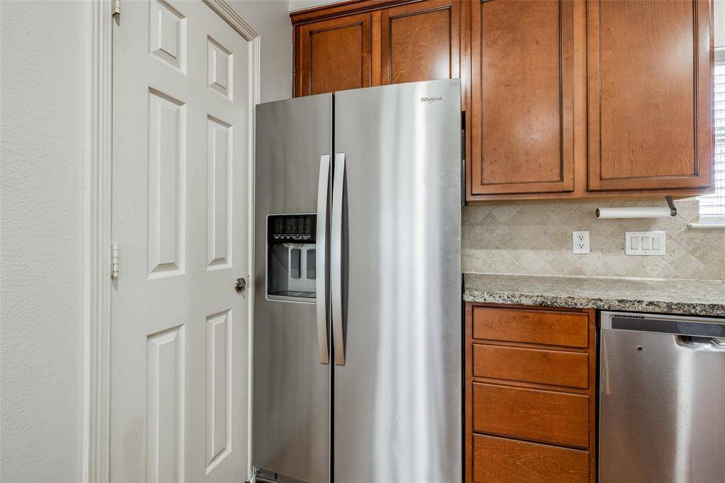 Stainless refrigerator stays with the home. Pantry to the left.