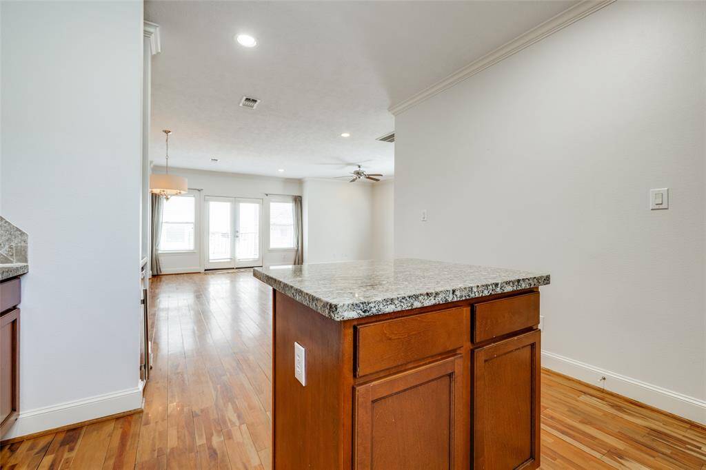 Kitchen island has cabinets and drawers for storage.