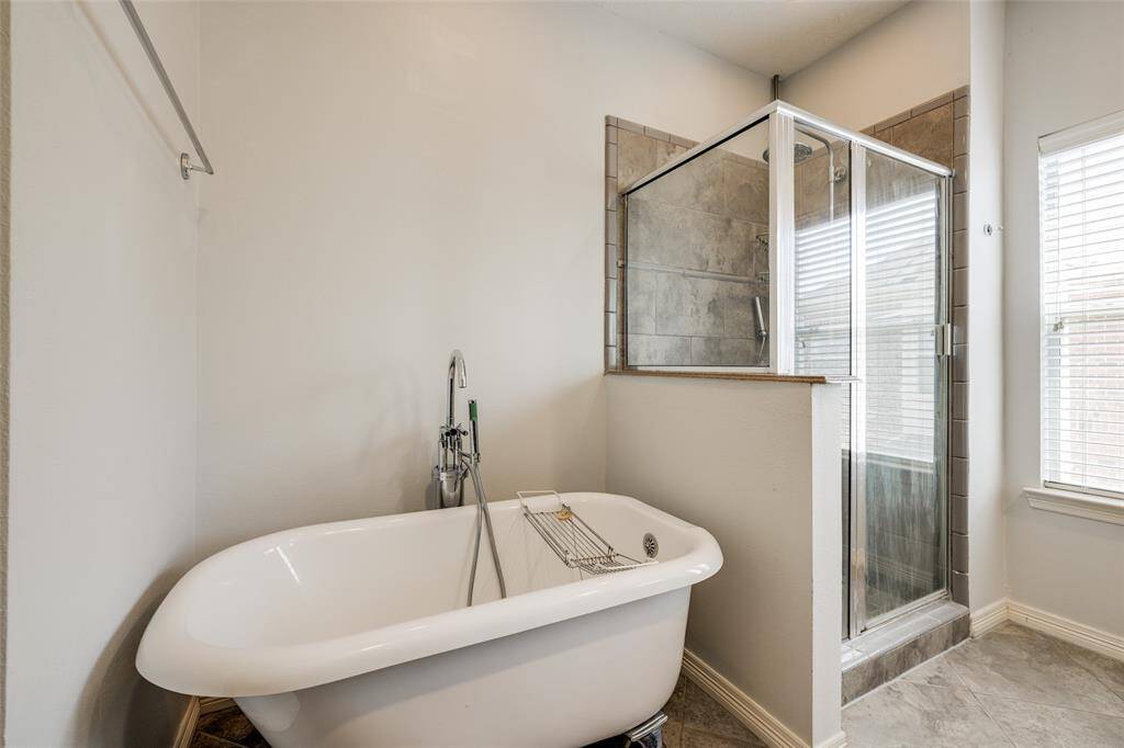 Cozy soaking tub with chrome hardware.