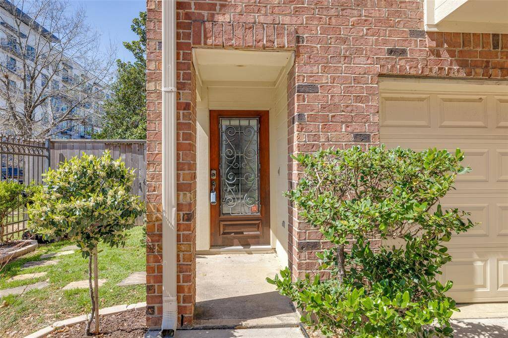 Unit is located on a corner with a side yard and fenced private backyard.