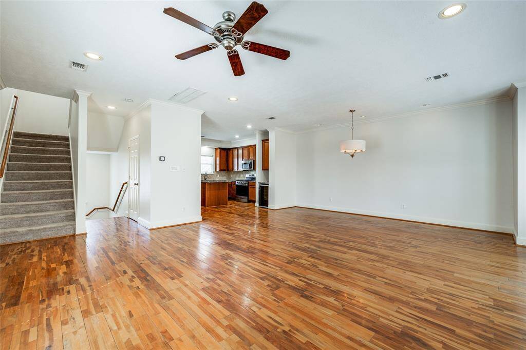 Spacious open concept living, dining and kitchen. Hardwood floors, recessed lighting and ceiling fan in this area.