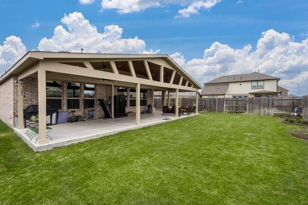 The expansive covered patio is perfect for relaxation, entertainment, and any outdoor activity you have in mind. Whether you're hosting a gathering, enjoying a quiet moment, or engaging in outdoor hobbies, this space offers both comfort and versatility, making it ideal for all your outdoor needs.