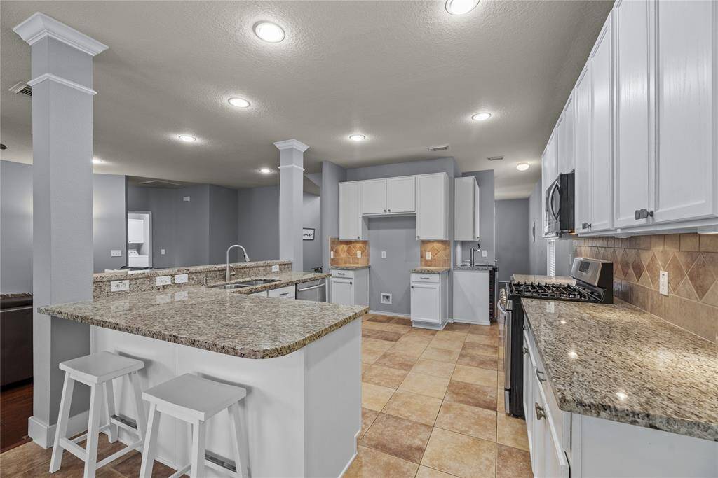 Granite countertops and under cabinet lighting in this upgraded kitchen.