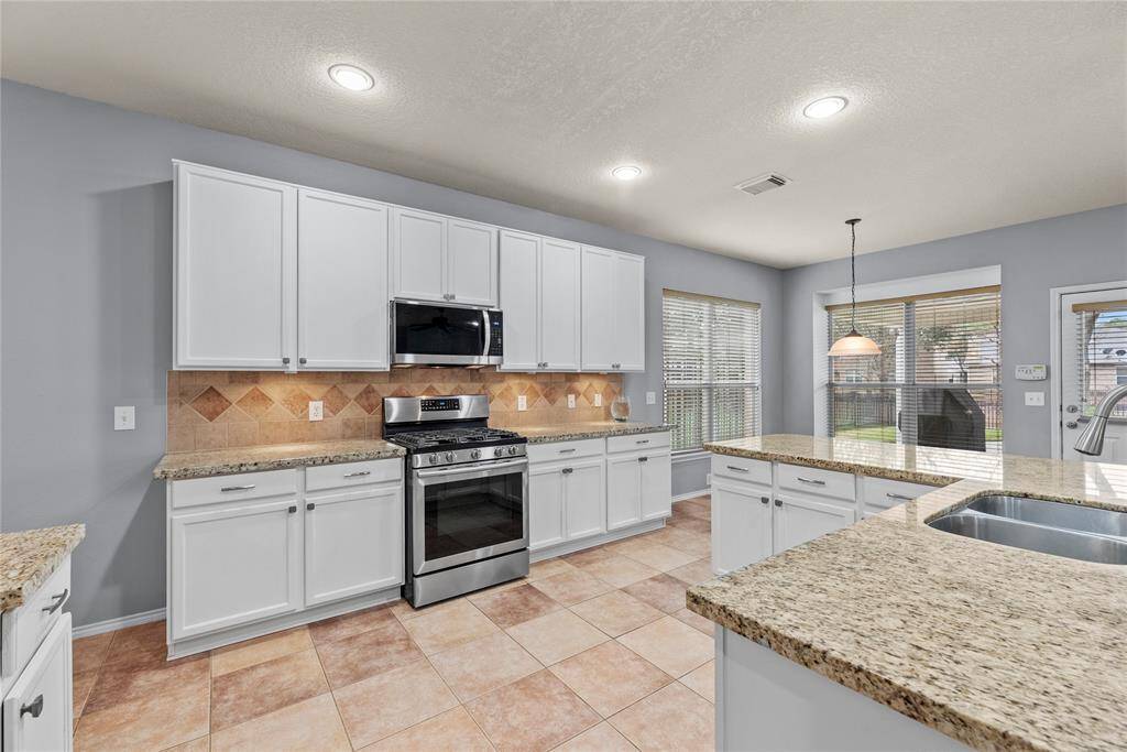Stainless steel appliances and lots of storage in your white cabinets.