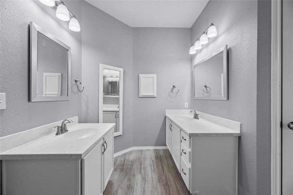 Updated primary bathroom with dual sinks.