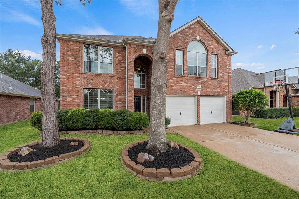 Brick exterior with mature trees for curb appeal.