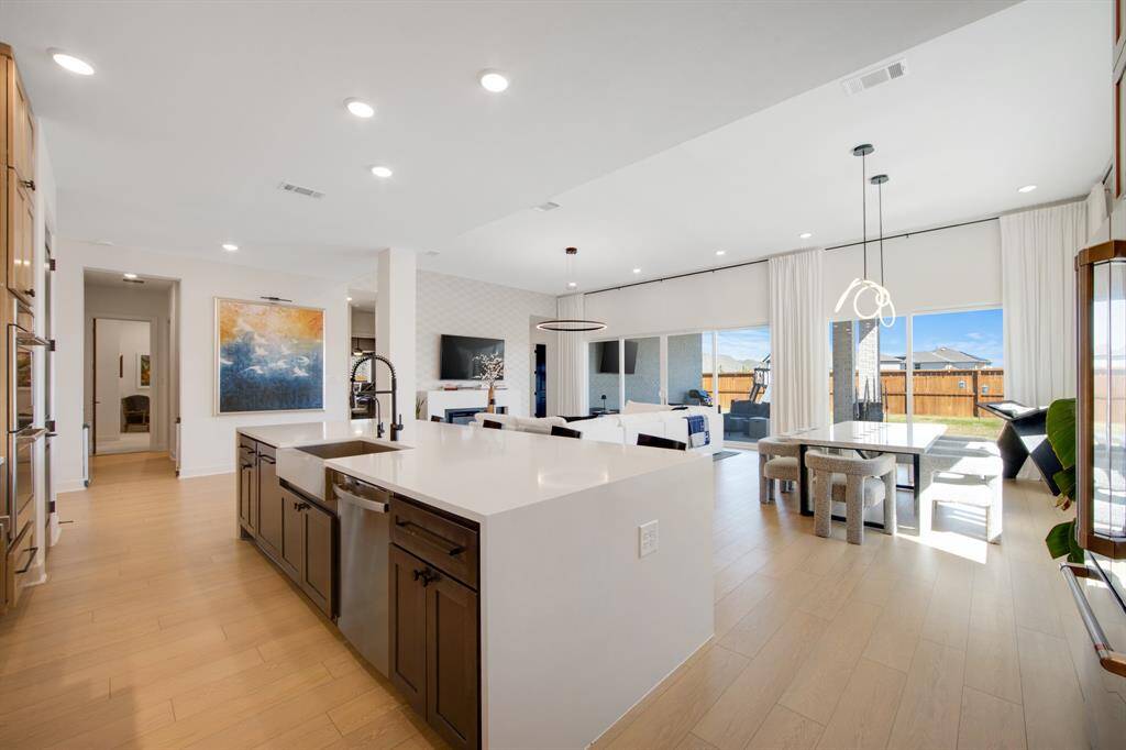 The kitchen features a built-in garbage bin drawer, providing a discreet and convenient way to keep waste out of sight while maintaining a clean, organized space.