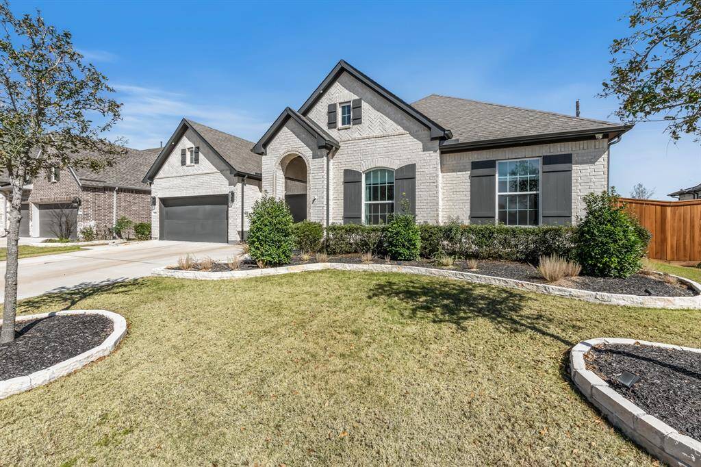 The home features a spacious 3-car garage with durable epoxy flooring and freshly painted walls, offering both functionality and a clean, modern aesthetic. The widened driveway provides extra space for parking, making it ideal for accommodating guests or additional vehicles. The beautifully landscaped yard is enhanced with elegant stone bordering all the flower beds.