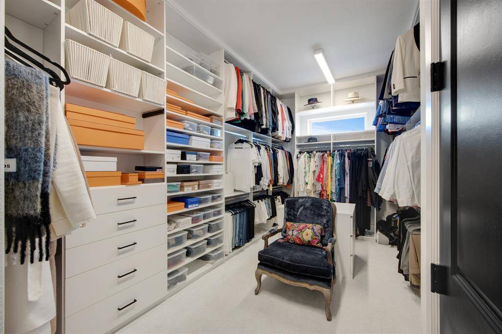 The custom primary closet is a true masterpiece, designed with impeccable attention to detail and offering abundant storage space. With its built-in shelves, hanging areas, and sleek organization, it seamlessly combines style and functionality.