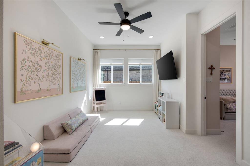 The children's retreat area is conveniently located near the two secondary bedrooms, offering a perfect space for play and relaxation. This cozy nook provides a dedicated area for activities while keeping the little ones close to their rooms.