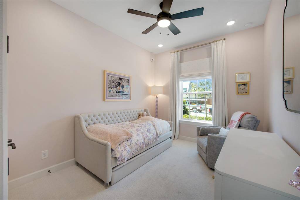 The secondary bedroom boasts plush carpeting that enhances its warmth and comfort, along with cellular shades that provide excellent light control and privacy. A beautiful custom closet offers ample storage space, keeping the room organized and stylish.