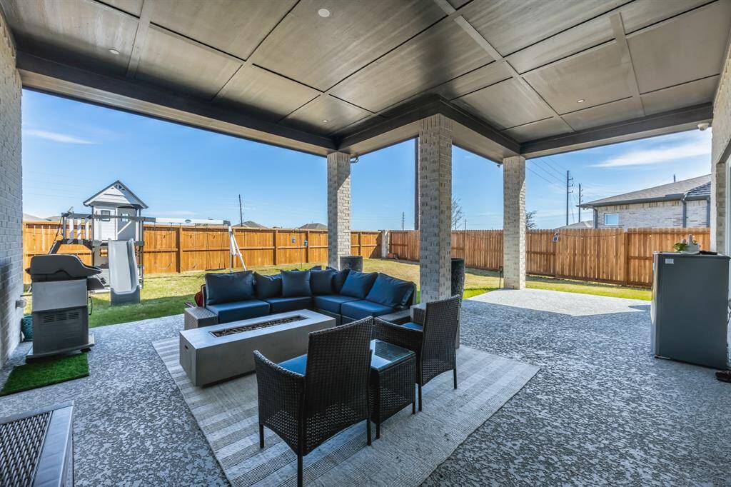 The large, extended covered patio is perfect for outdoor relaxation, featuring stylish stamped concrete that adds texture and charm. The stained fence offers privacy and beauty, while fence lighting creates a warm, inviting ambiance, and the home is wired for an exterior generator with a 50-amp breaker for added convenience and peace of mind.