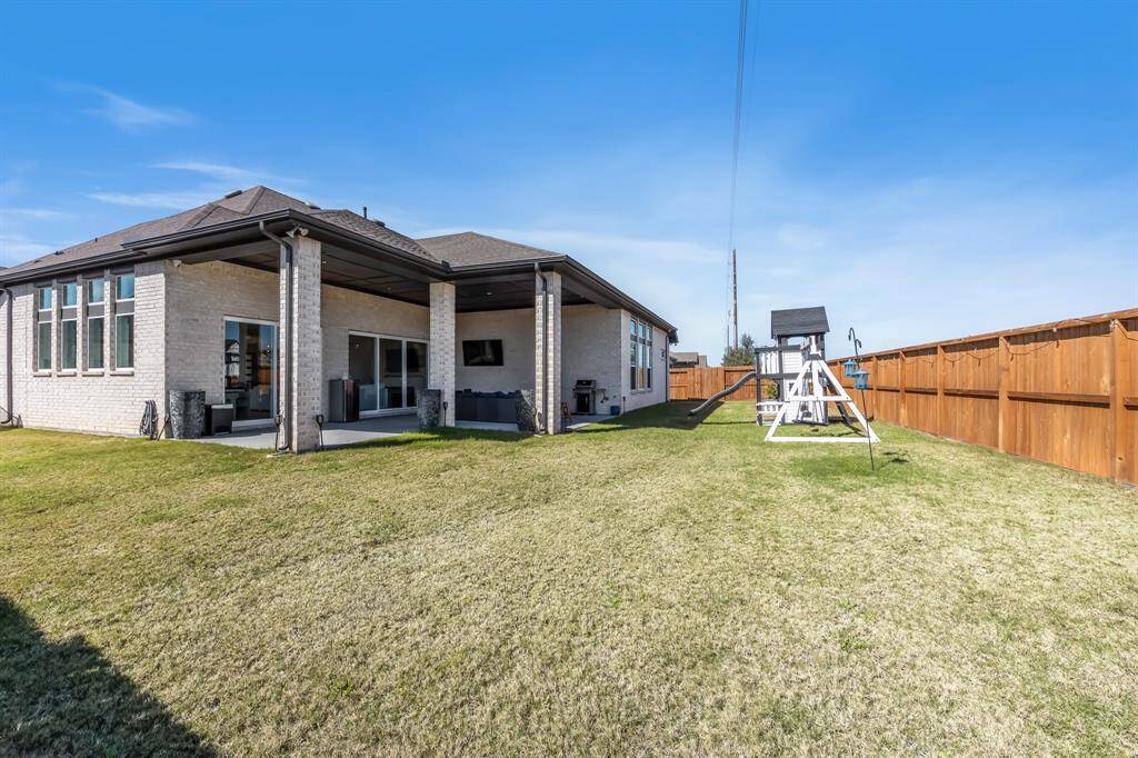 The large, extended covered patio is perfect for outdoor relaxation, featuring stylish stamped concrete that adds texture and charm. The stained fence offers privacy and beauty, while fence lighting creates a warm, inviting ambiance, and the home is wired for an exterior generator with a 50-amp breaker for added convenience and peace of mind.
