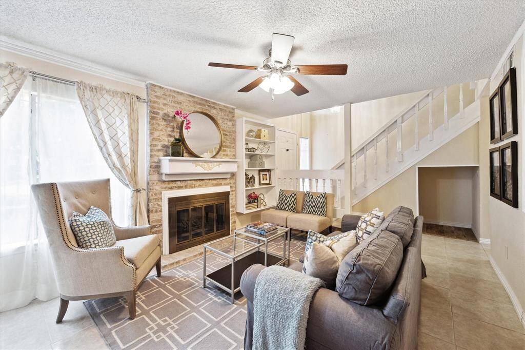 Another view of the spacious living area with tile flooring with cozy fireplace.