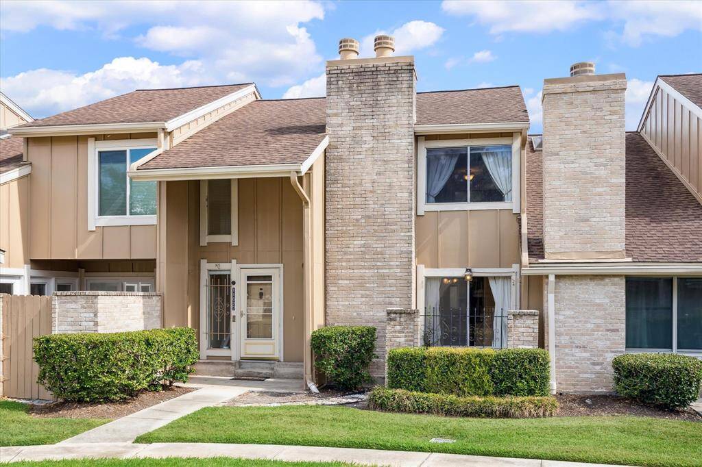 This two-story townhome features a mix of brick and recent cement board exterior.  The front entry has a covered porch, and there are large windows on both floors, providing ample natural light. LThe home is located on the best courtyard near the pool and is surrounded by lush landscaping and mature trees.