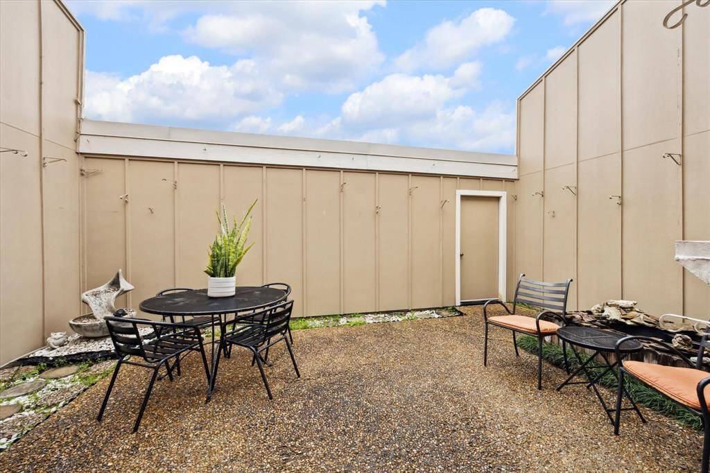 This outdoor patio is private and is located between the home and the garage.