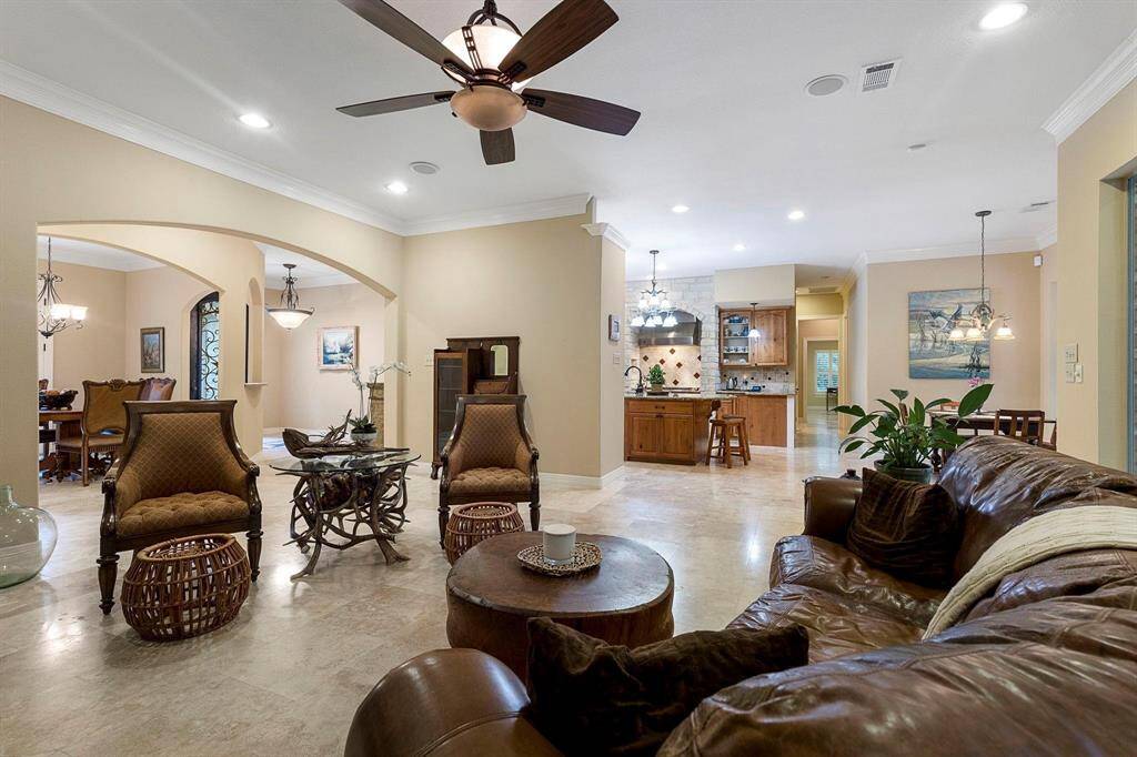 Travertine flooring throughout front living area.