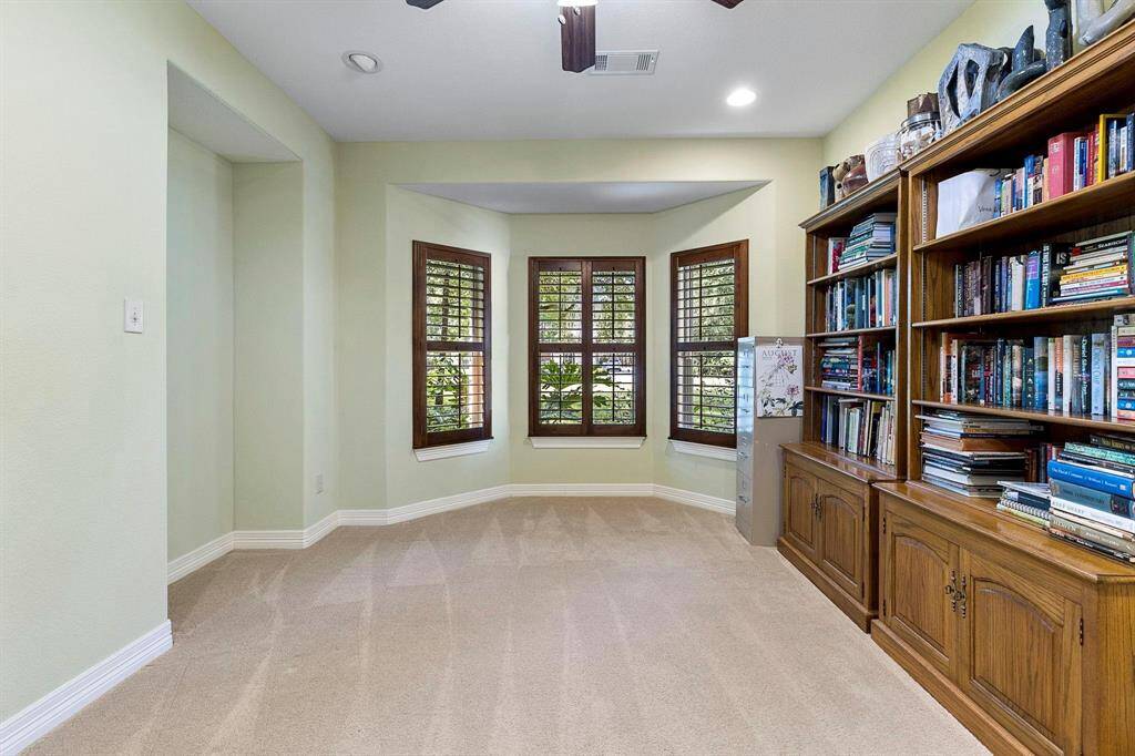 Home office with windows to the front yard.  Great space for the remote worker.